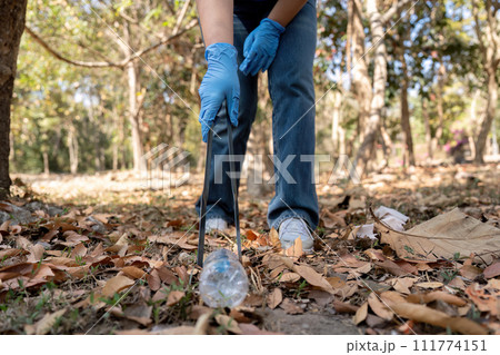 Young people friend volunteer collecting garbage plastic bottles to trash bags. environmental care ecology concept Young people friend volunteer collecting garbage plastic bottles to trash bags. environmental care ecology concept 111774151