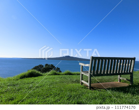 ニュージーランド、オークランドの海とランギトト島を見渡す景色の綺麗なベンチ ニュージーランド、オークランドの海とランギトト島を見渡す景色の綺麗なベンチ 111774170