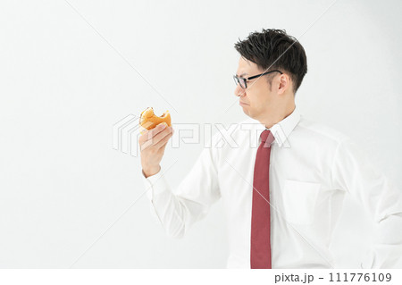 ハンバーガーを食べるビジネスマン 111776109