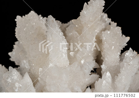 Macro stone Calcite mineral on a black background 111776502