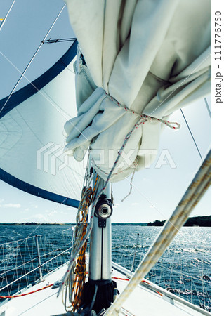 Yachting on sail boat during sunny weather Yachting on sail boat during sunny weather 111776750