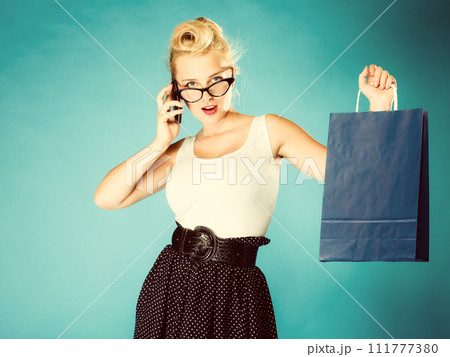 Pin up woman with shopping bag and phone. Pin up woman with shopping bag and phone. 111777380