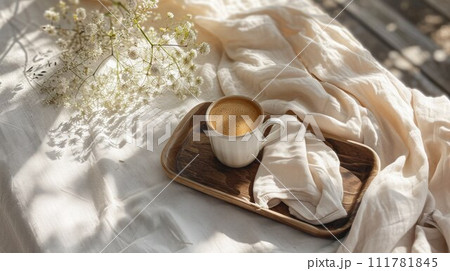 Coffee in bed, romantic morning. Flowers, an open book and a cup of coffee on a wooden tray. Home cozy interior, lifestyle 111781845