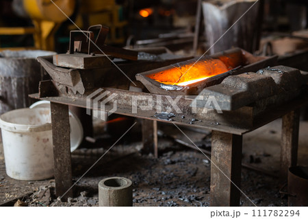 Mold with molten metal in the foundry workshop of metallurgical plant 111782294