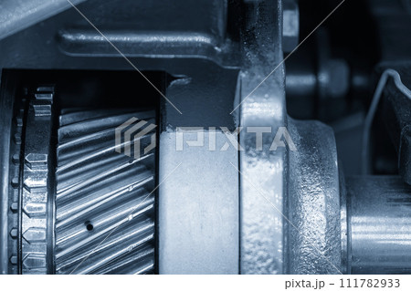 Close up scene the broken teeth transmission gear parts in the light blue scene. 111782933