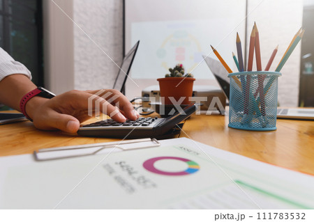 Financial businessman accounting calculating cost economic budget in home office. Investment and saving concept. Financial businessman accounting calculating cost economic budget in home office. Investment and saving concept. 111783532