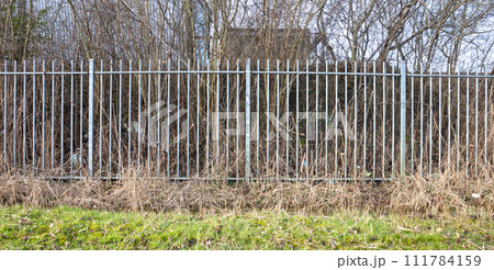 High metal fence, keeping unwanted visitors out High metal fence, keeping unwanted visitors out 111784159