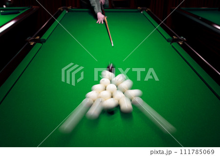 Strong hit by a player with a billiard cue on the ball Strong hit by a player with a billiard cue on the ball 111785069