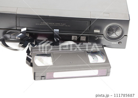 Retro video cassette recorder with VHS cassette with unwound tape isolated on white background. 111785687