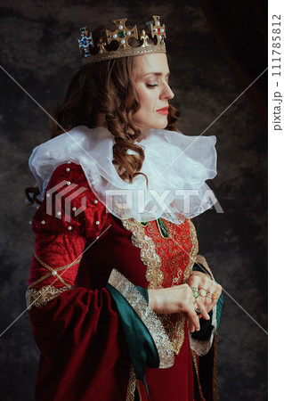 medieval queen in red dress with white collar and crown medieval queen in red dress with white collar and crown 111785812