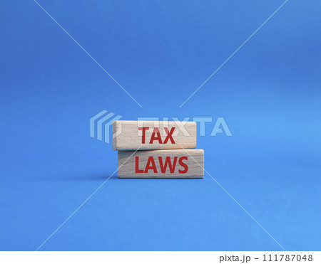 Tax Laws symbol. Concept word Tax Laws on wooden blocks. Beautiful blue background. Business and Tax Laws concept. Copy space 111787048