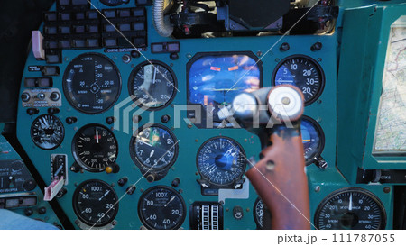 Inside the cabin of the Mi-24 military transport helicopter. Close-up of the control panel, instruments, gauges and steering wheel. A Russian military helicopter. 111787055