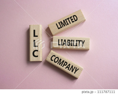 LLC - Limited liability company. Wooden cubes with word LLC. Beautiful pink background. Business and LLC concept. Copy space. LLC - Limited liability company. Wooden cubes with word LLC. Beautiful pink background. Business and LLC concept. Copy space. 111787111