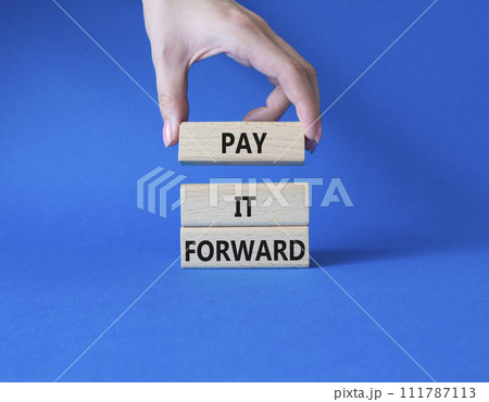 Pay it forward symbol. Concept words Pay it forward on wooden blocks. Beautiful blue background. Businessman hand. Business and Pay it forward concept. Copy space. Pay it forward symbol. Concept words Pay it forward on wooden blocks. Beautiful blue background. Businessman hand. Business and Pay it forward concept. Copy space. 111787113