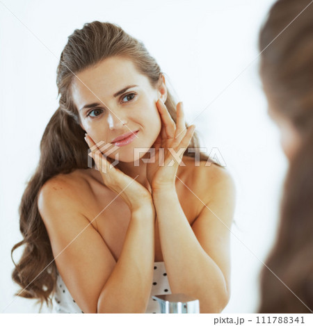 Young woman checking facial skin condition 111788341