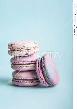 Pink macaroons on blue background close-up and empty space 111788585