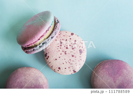 Pink macaroons on blue background close-up and empty space Pink macaroons on blue background close-up and empty space 111788589