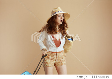 modern female in white blouse and shorts isolated on beige 111788649