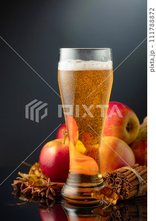 Apple cider in high glass on a black background. Apple cider in high glass on a black background. 111788872