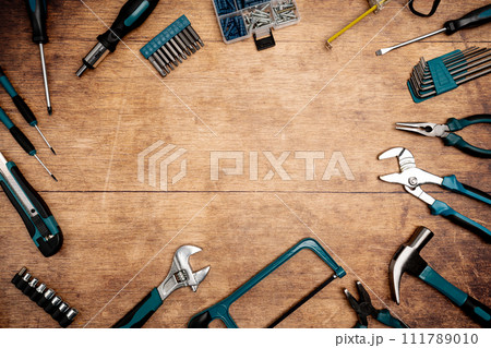 Set of tools on wooden background, 111789010