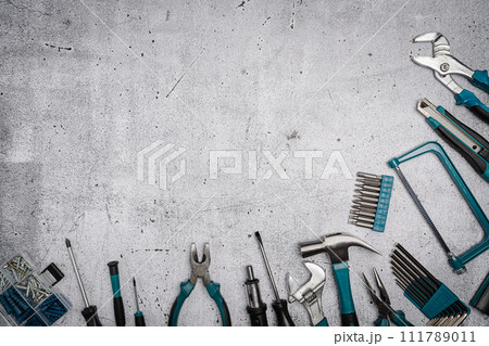 Set of tools on concrete background, 111789011