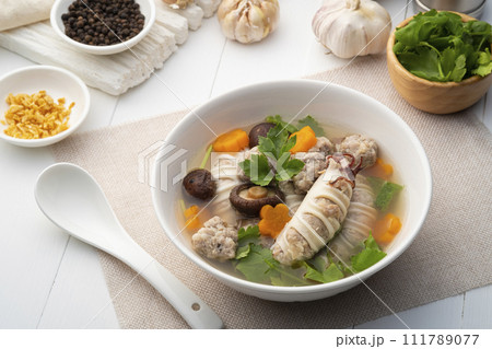 Stuffed squid soup,Clear Soup with Squid Stuffed with Minced Pork and dried shiitake mushroom in white bowl 111789077