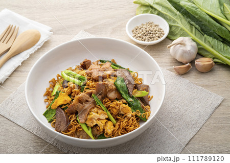 Stir-fried Instant Noodles with Soy Sauce and Pork in white plate.Asian food Stir-fried Instant Noodles with Soy Sauce and Pork in white plate.Asian food 111789120