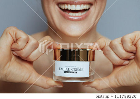Closeup on woman with cosmetic cream jar Closeup on woman with cosmetic cream jar 111789220