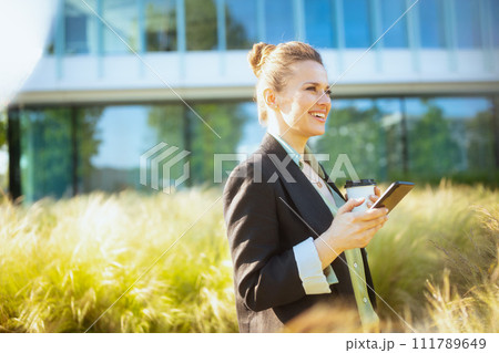 happy female worker in business district using smartphone happy female worker in business district using smartphone 111789649