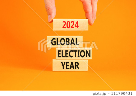 2024 global election year symbol. Concept words 2024 global election year on beautiful block. Beautiful orange table background. Voter hand. Business 2024 global election year concept. Copy space 2024 global election year symbol. Concept words 2024 global election year on beautiful block. Beautiful orange table background. Voter hand. Business 2024 global election year concept. Copy space 111790431