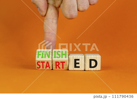Started and finished symbol. Businessman turns beautiful wooden cubes and changes word Started to Finished. Beautiful orange table orange background. Business started and finished concept. Copy space. 111790436