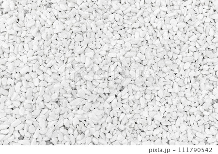 Smooth white pebble, top view, close-up background texture Smooth white pebble, top view, close-up background texture 111790542