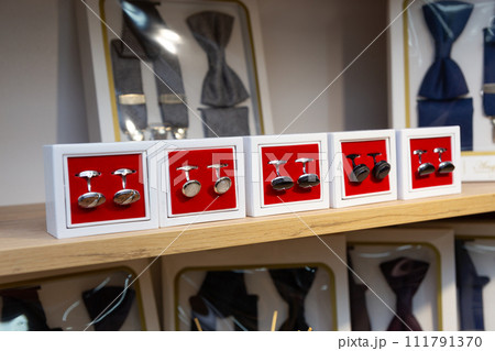 Boxes with cufflinks on shelf in boutique. Boxes with cufflinks on shelf in boutique. 111791370