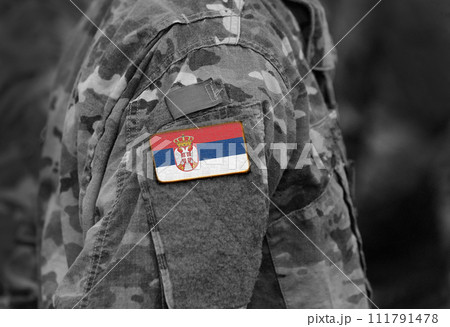 Flag of Serbia on soldiers arm (collage). 111791478