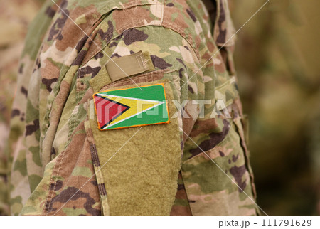 Guyana flag on soldiers arm. Co-operative Republic of Guyana troops (collage) 111791629
