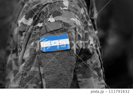 Flag of Honduras on soldier arm. Flag of Honduras on military uniforms (collage). 111791632