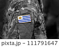 Flag of Uruguay on soldiers arm. Flag of Uruguay on military uniforms (collage). 111791647