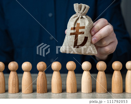 A man holds a turkish lira money bag above the crowd. Deposits and loans. Salaries. Crowdfunding and fundraising. Social politics. Budgetary funds for social policy. 111792053