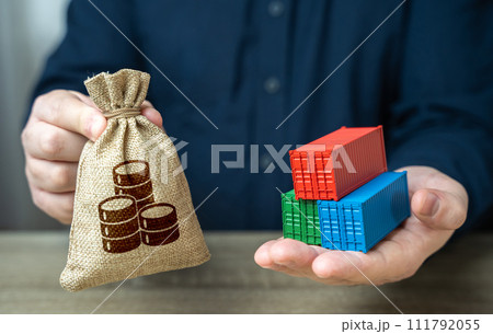 Trade containers and a money bag in the hands of a businessman. Economic growth, production and development of transport infrastructure. Make a trade deal. Import and export. Profit from sale of goods 111792055