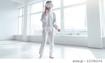 a young girl of European appearance, in casual clothes, in a modern bright room wearing a white VR virtual reality headset. daylight a young girl of European appearance, in casual clothes, in a modern bright room wearing a white VR virtual reality headset. daylight 111792141