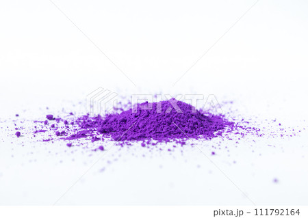 a bunch of dry natural purple pigment on a white background macro a bunch of dry natural purple pigment on a white background macro 111792164