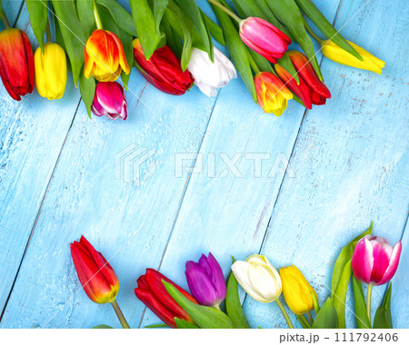 Bouquet of tulips on blue wooden table. Happy women's day. 8 March., Mother's Day. Flat lay and copy space Bouquet of tulips on blue wooden table. Happy women's day. 8 March., Mother's Day. Flat lay and copy space 111792406