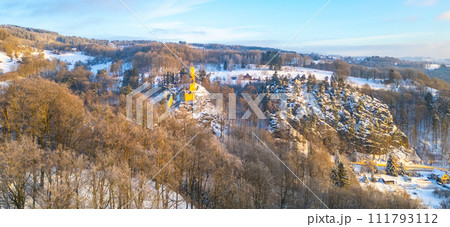 Frydstejn medieval castle ruins at cold morning sunrise time. Bohemian Paradise, Czech: Cesky raj, Czechia. Aerial view from above. 111793112