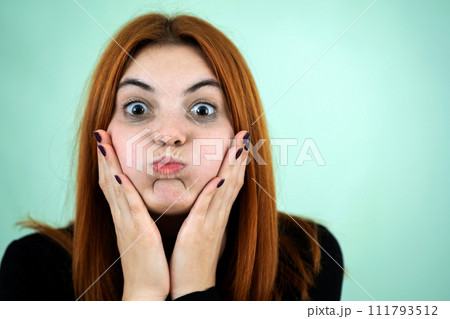 Happy pretty redhead girl looking laughing in camera in surprise 111793512