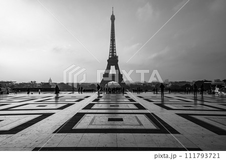 Eiffel Tower, French: Tour Eiffel, silhouette at dawn. View from Trocadero Square with geometrical marble pavement. Paris, France. Black and white photography. 111793721