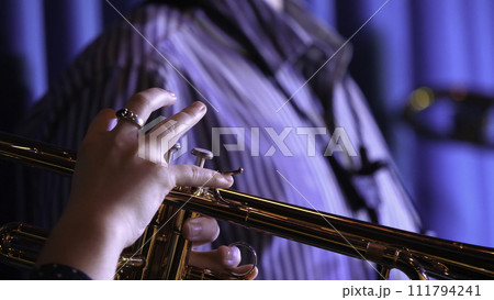 Trumpet player. Trumpeter hands playing brass music instrument close up Trumpet player. Trumpeter hands playing brass music instrument close up 111794241