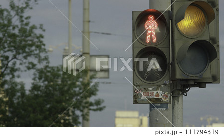 Close up urban city traffic light changing to green from red signal cars to proceed across intersection. Safety for drivers and pedestrians in crosswalk. Traffic light for pedestrians 111794319