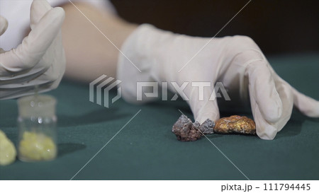 Scientist or archaeologist holding stones or minerals in hands. People with samples of archeology in the hands of Scientist or archaeologist holding stones or minerals in hands. People with samples of archeology in the hands of 111794445