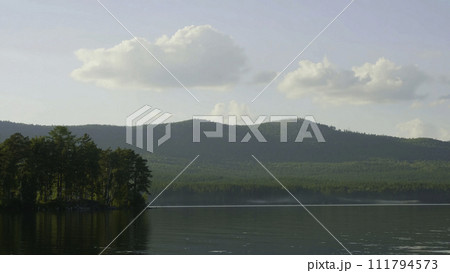 Summer landscape with river, cloudy sky, forest and sun timelapse. summer landscape with river and blue sky time lapse. Amazing clouds on the lake coast Summer landscape with river, cloudy sky, forest and sun timelapse. summer landscape with river and blue sky time lapse. Amazing clouds on the lake coast 111794573