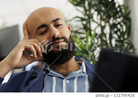 Arab entrepreneur discussing company growth strategy in videocall using digital tablet. Executive manager listening to sales report presentation in video conference call in office 111795428